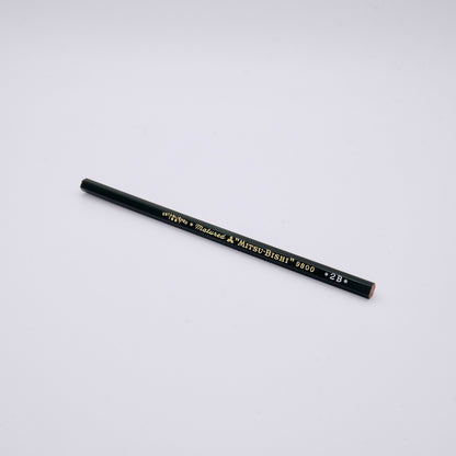 pencil with gold text on a light gray background