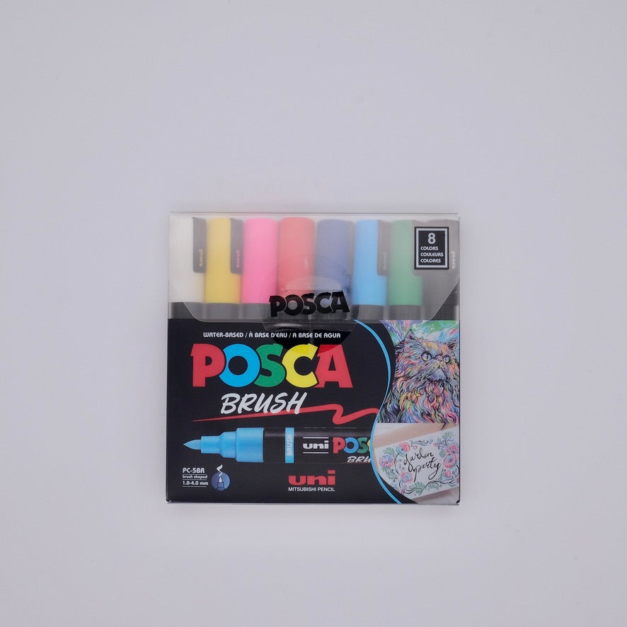 Pack of Posca brush markers with colorful caps on a gray background