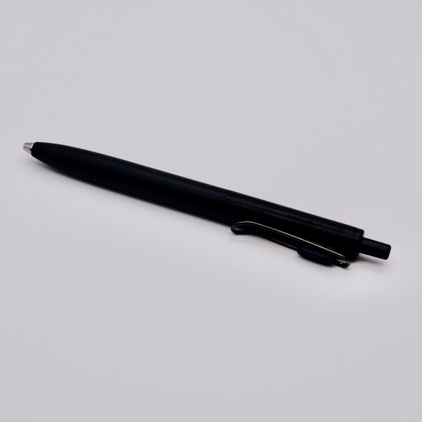 Black pen on a light gray background