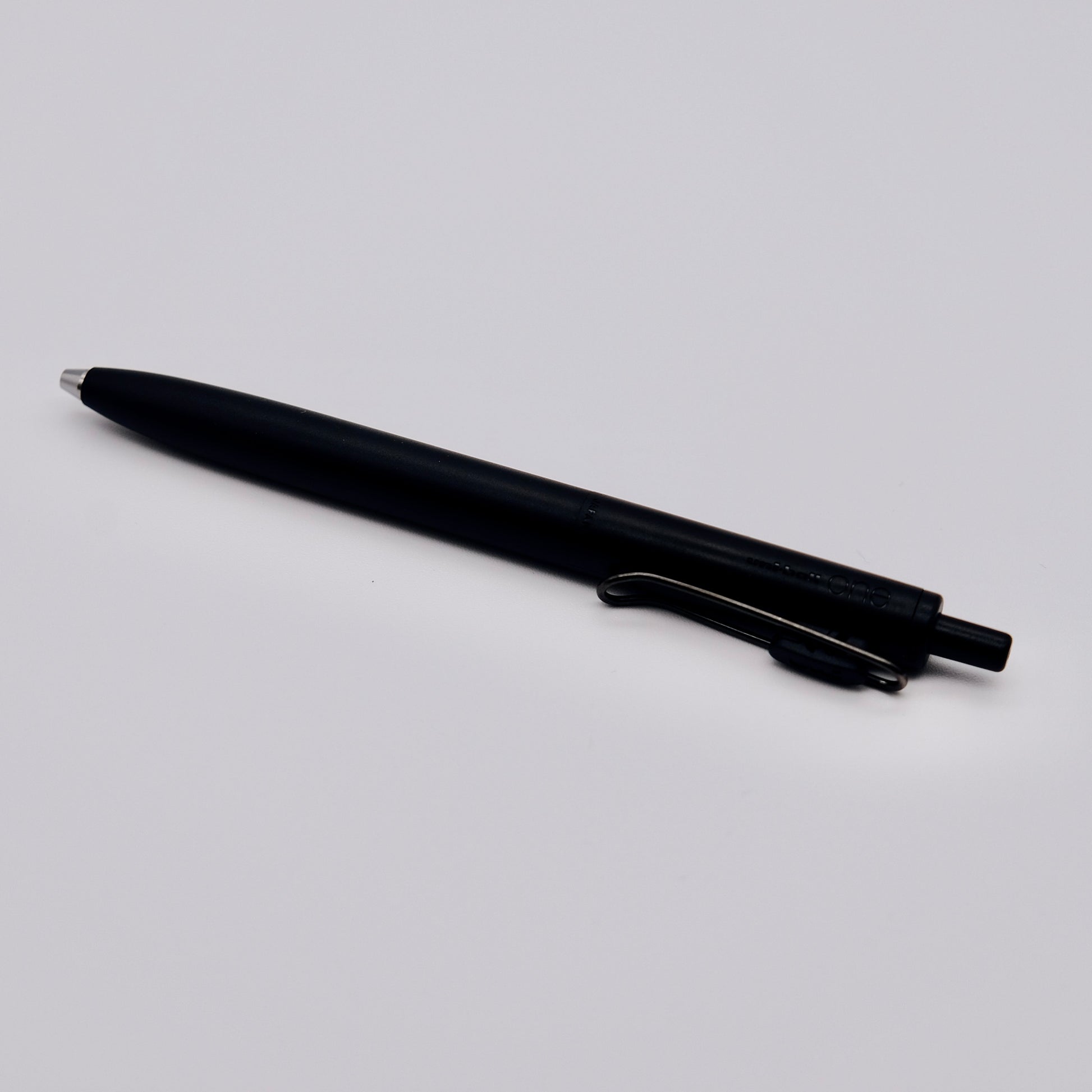 Black pen on a light gray background