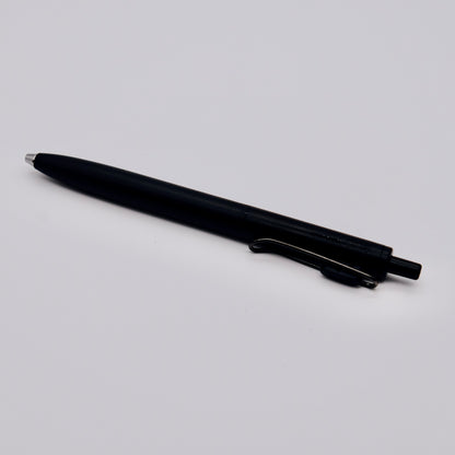 Black pen on a light gray background