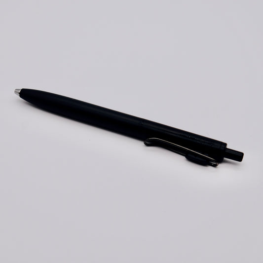 Black pen on a light gray background