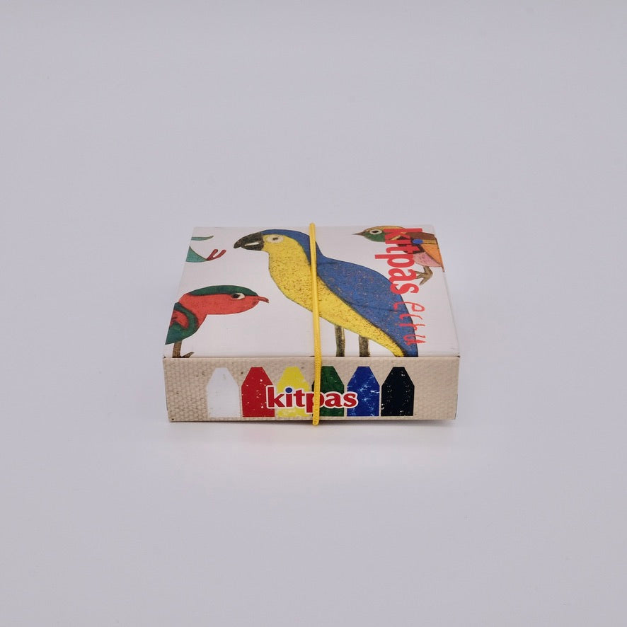 Small box with colorful bird design and 'kitpas' branding on a light gray background