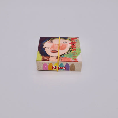 Colorful box with a face design and kitpas branding on a light gray background