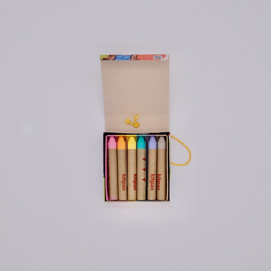 Set of colorful crayons in a box on a light gray background