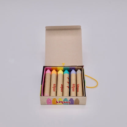 Set of colorful crayons in a box with 'kitpas' branding on a white background