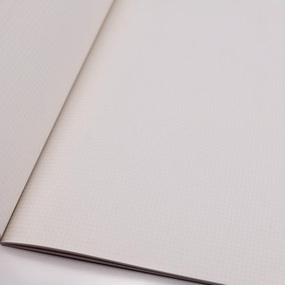 Close-up of notebook with tiny grid pages