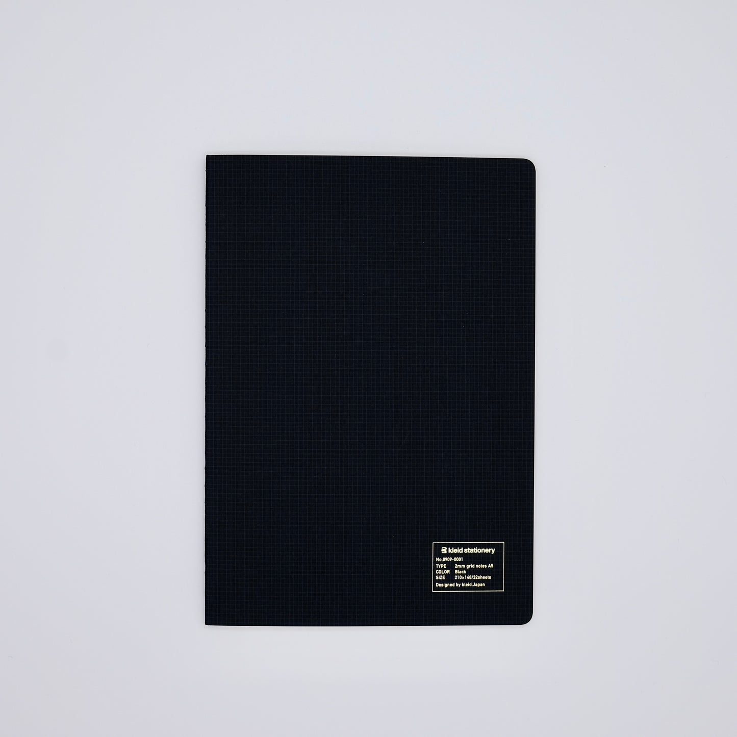 Black textured notebook on a light gray background