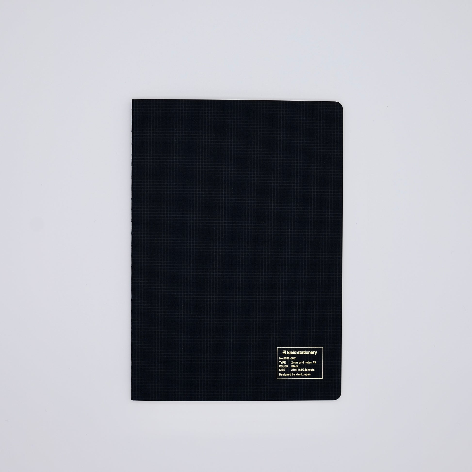 Black textured notebook on a light gray background
