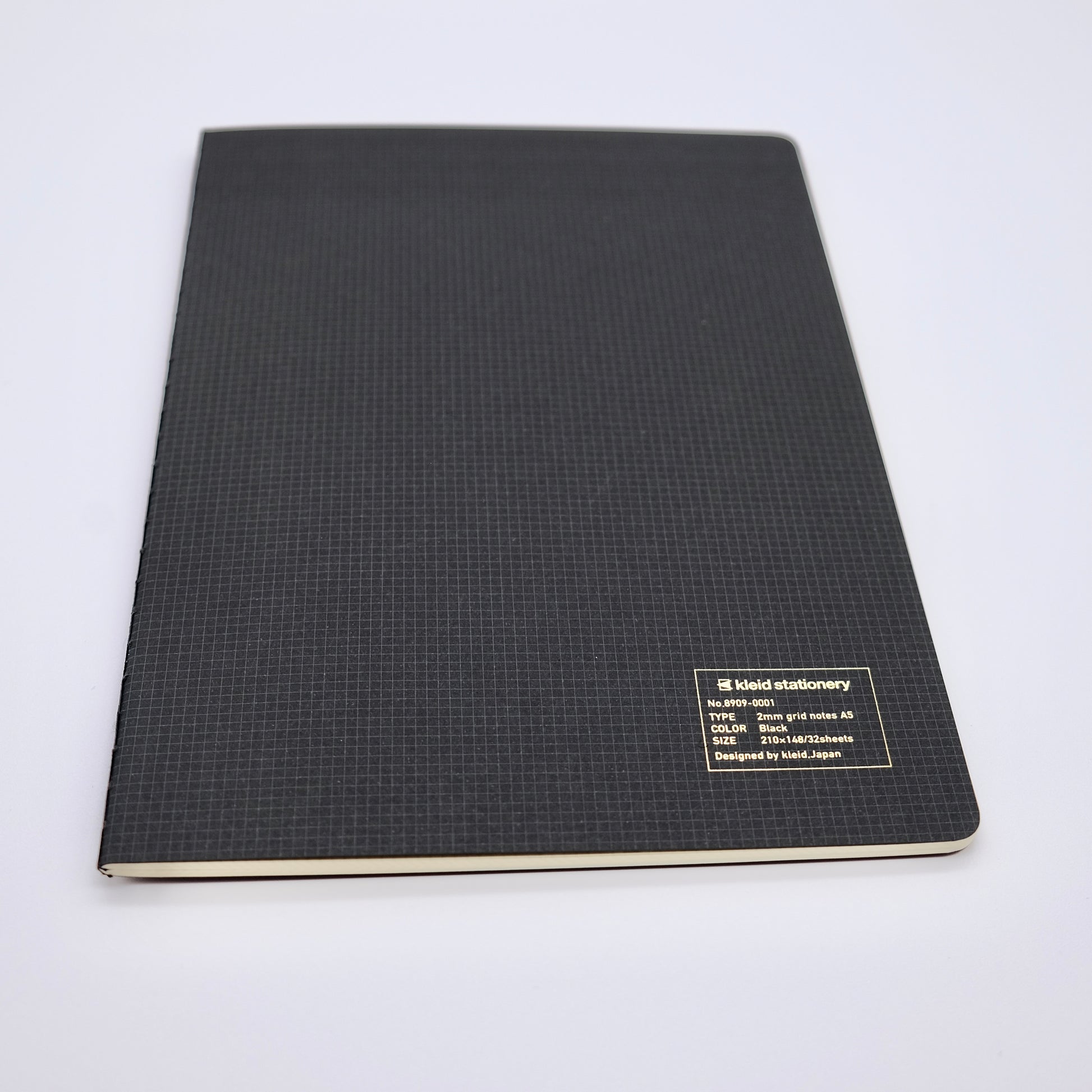 Black notebook with grid pattern on a white background