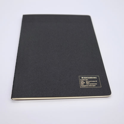 Black notebook with grid pattern on a white background