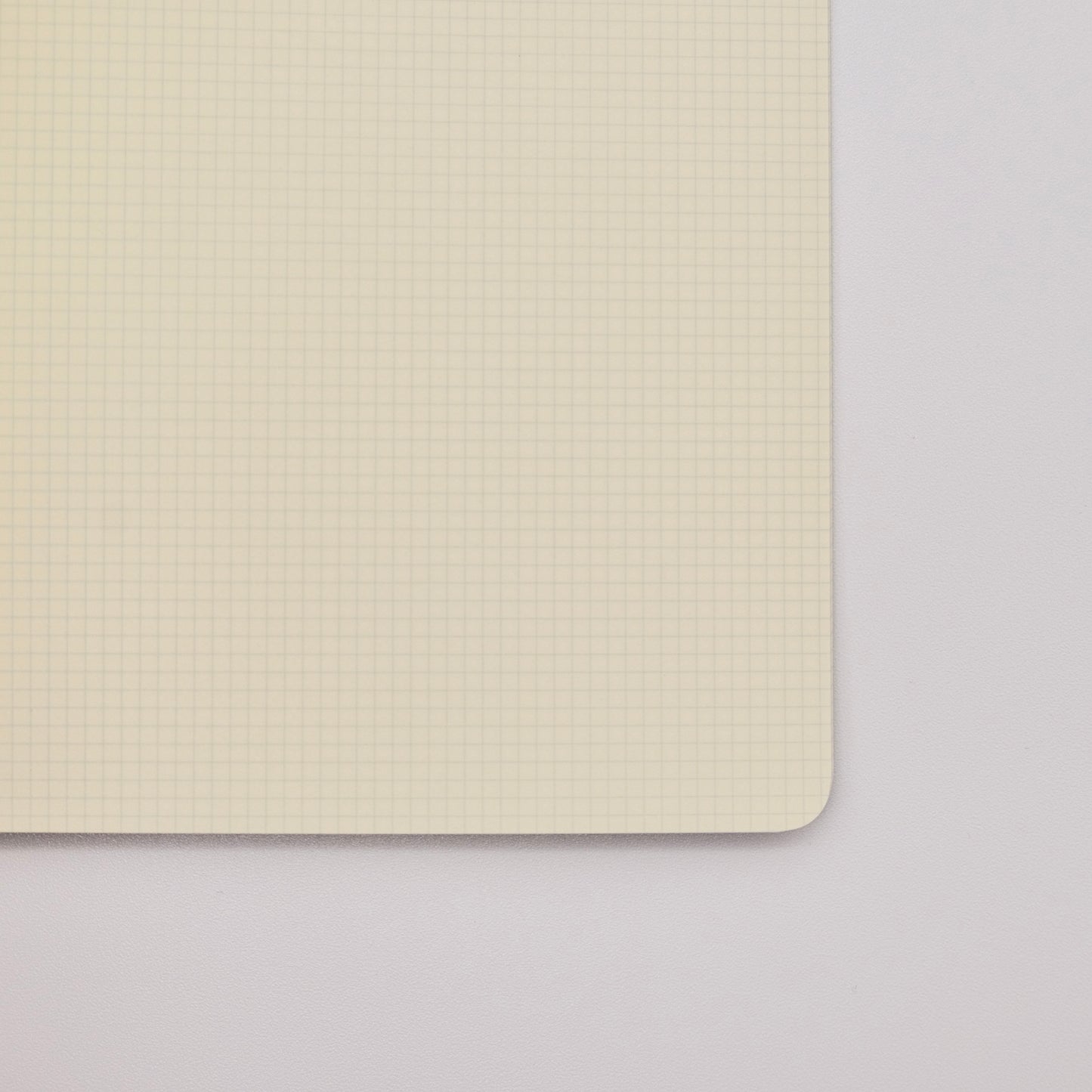 Notebook interior with 2mm grid pages on a light gray background