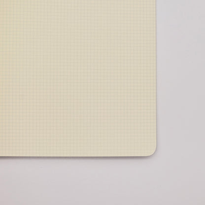 Notebook interior with 2mm grid pages on a light gray background