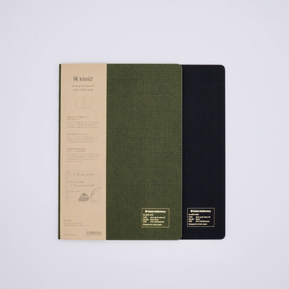 Two
 notebooks with different covers on a light gray background