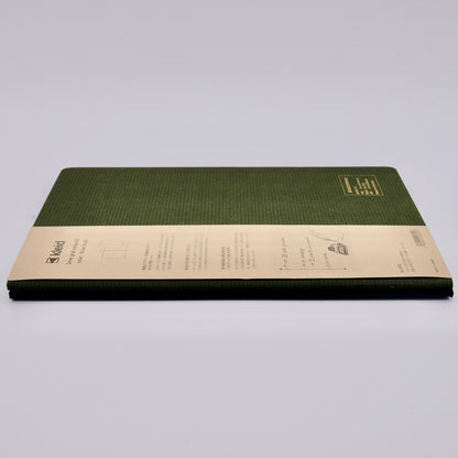 Green notebook with beige label on a light gray background