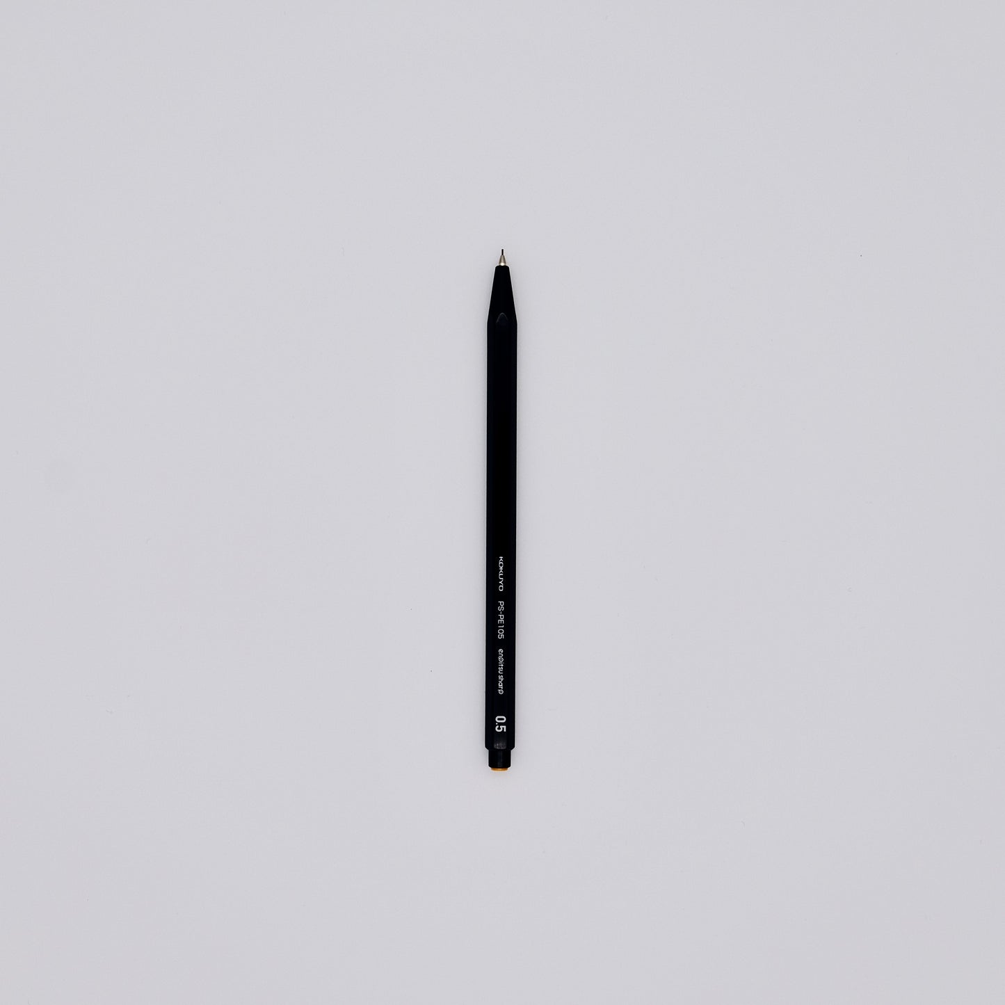 Black mechanical pencil on a light gray background
