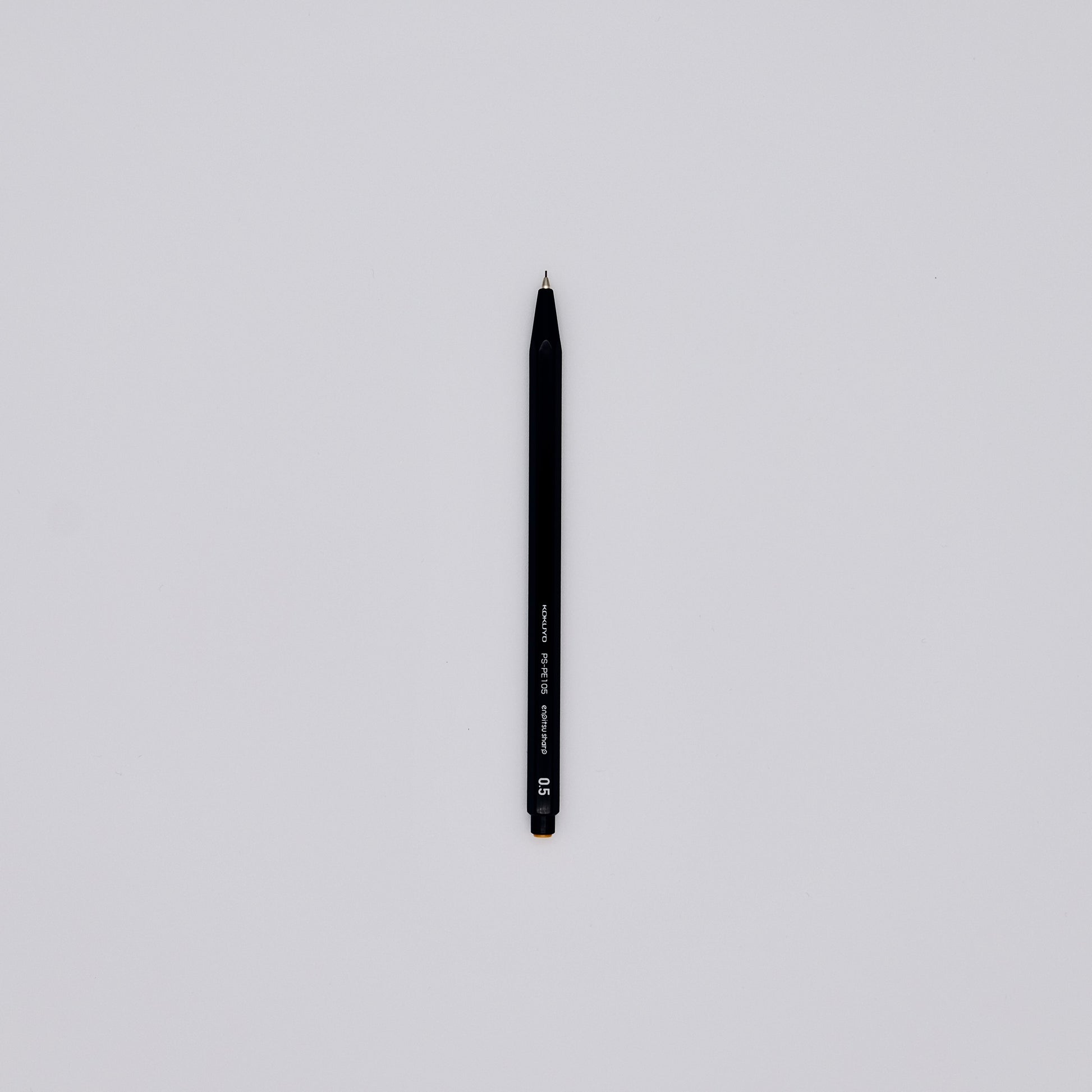 Black mechanical pencil on a light gray background