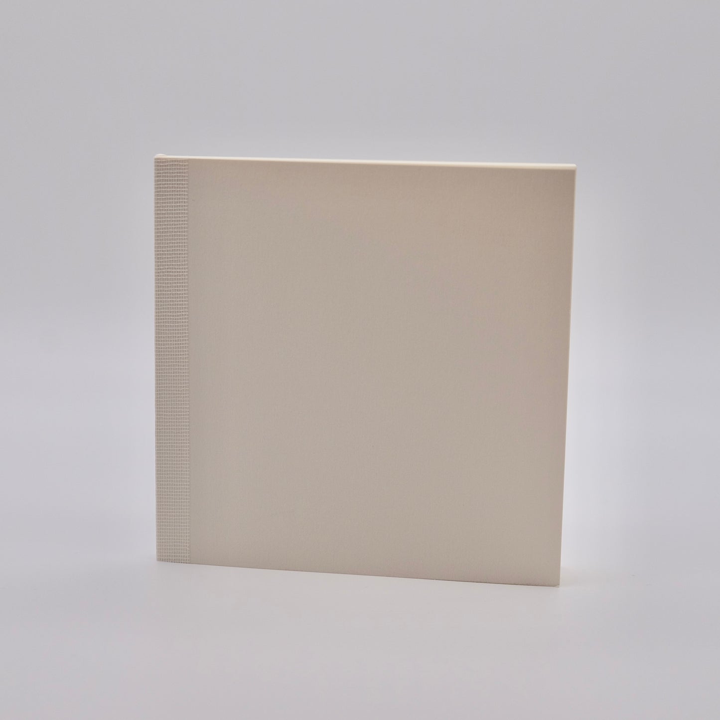 Square notebook with textured edge on a light gray background