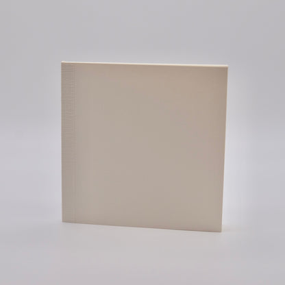 Square notebook with textured edge on a light gray background