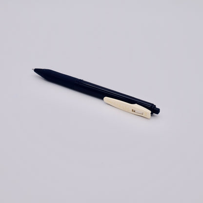 Dark blue pen with a beige clip on a light gray background