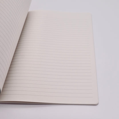 Open notebook with lined pages on a light gray background