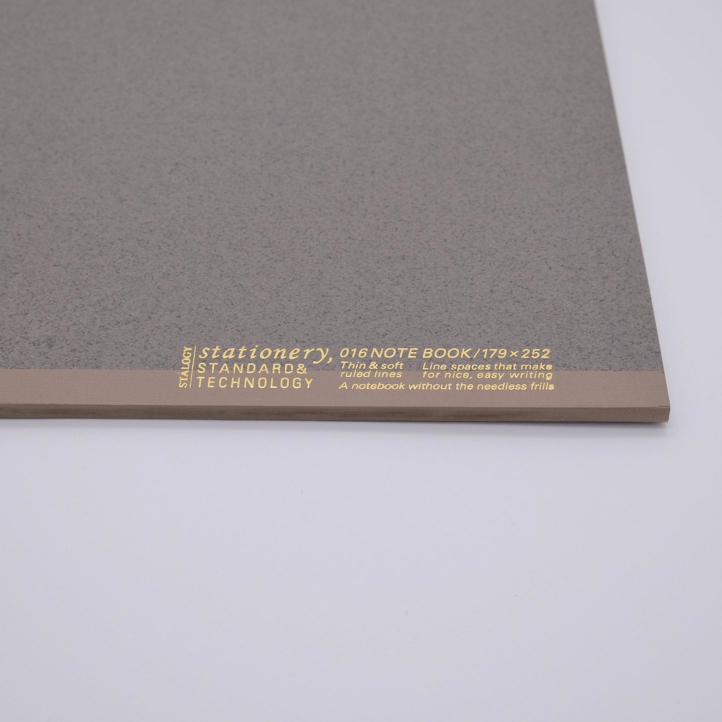Gray notebook with gold text on a white background