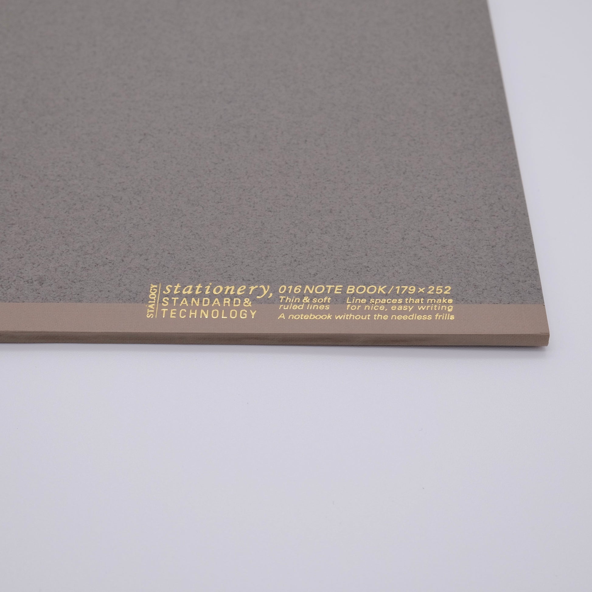 Gray notebook with gold text on a white background