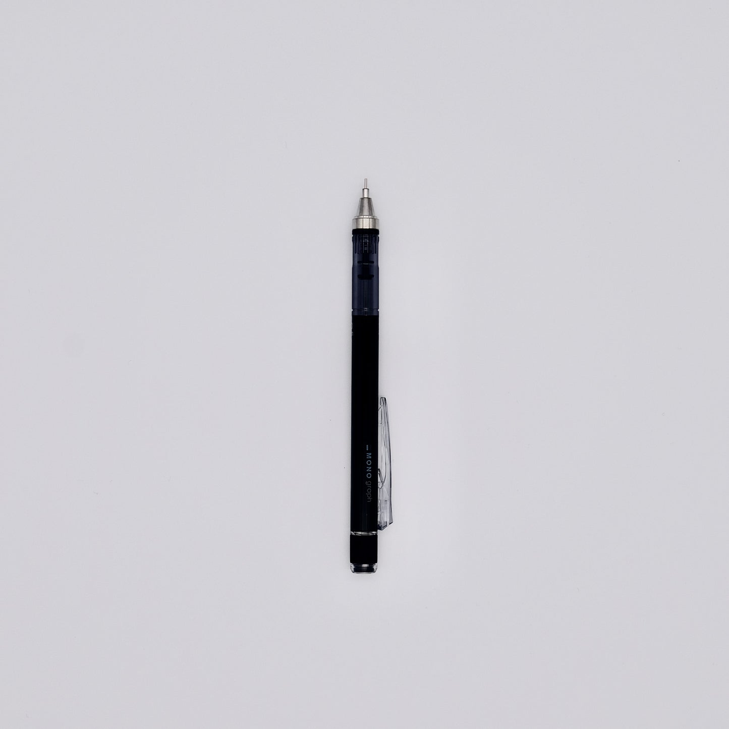 Black mechanical pencil with silver accents on a light gray background