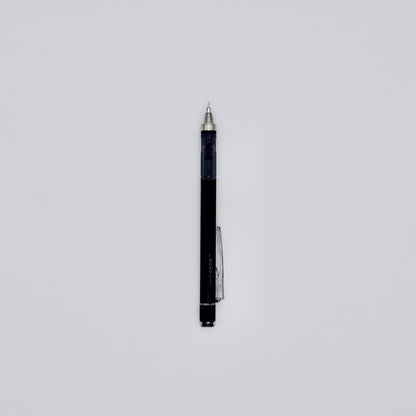 Black mechanical pencil with silver accents on a light gray background