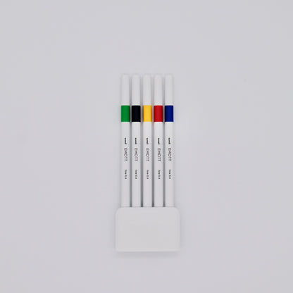 Set of white pens with colored bands in a holder on a light gray background