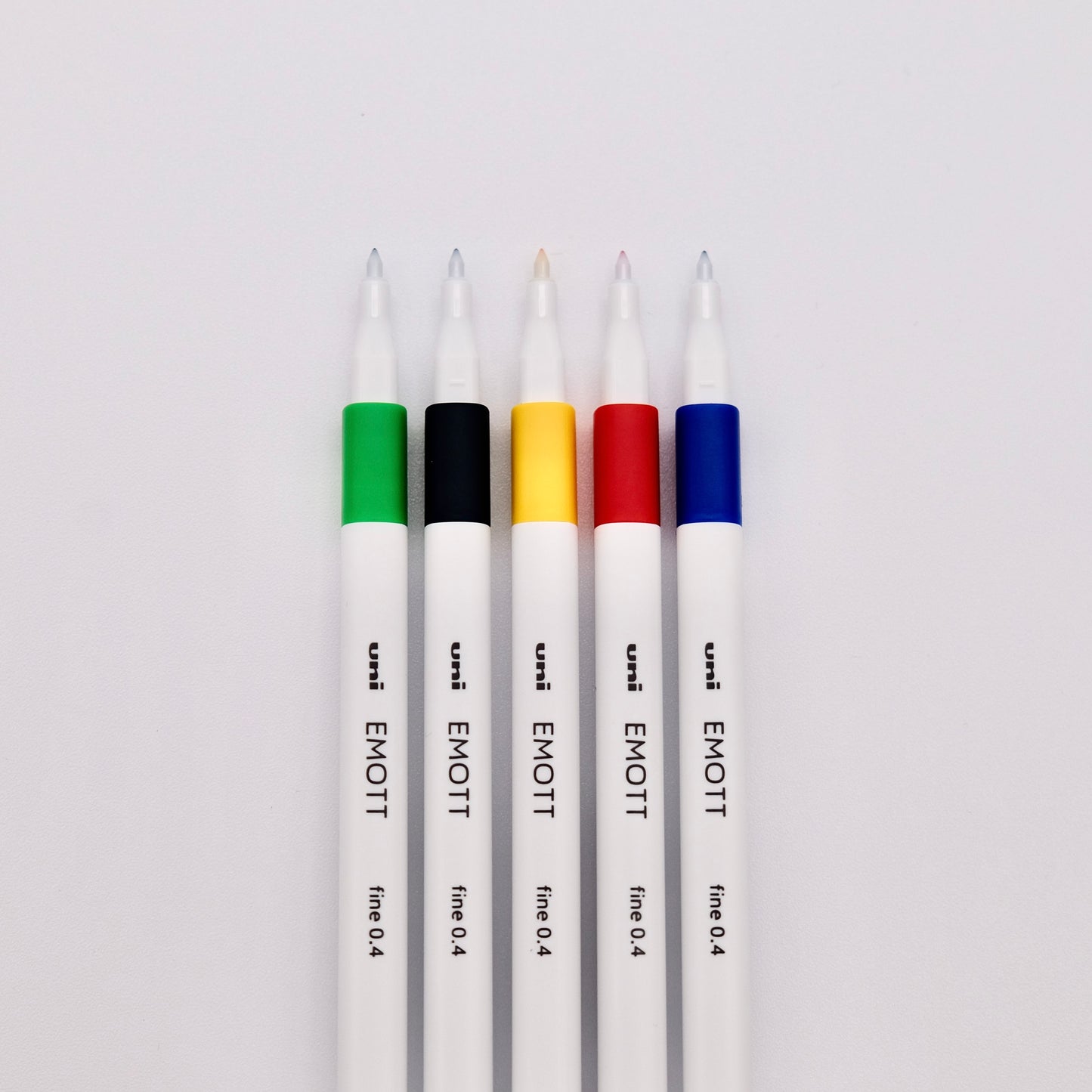 Five uni EMOTT pens on a white background
